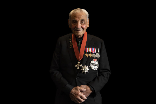 A portrait of Sir Robert Gillies against a plain backdrop, wearing a suit and medals.