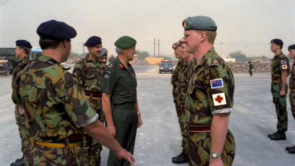 Gerard Wood standing at attention in an Army uniform with a red medical cross on his arm